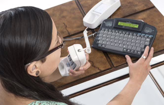 woman talking into phone using captioning device